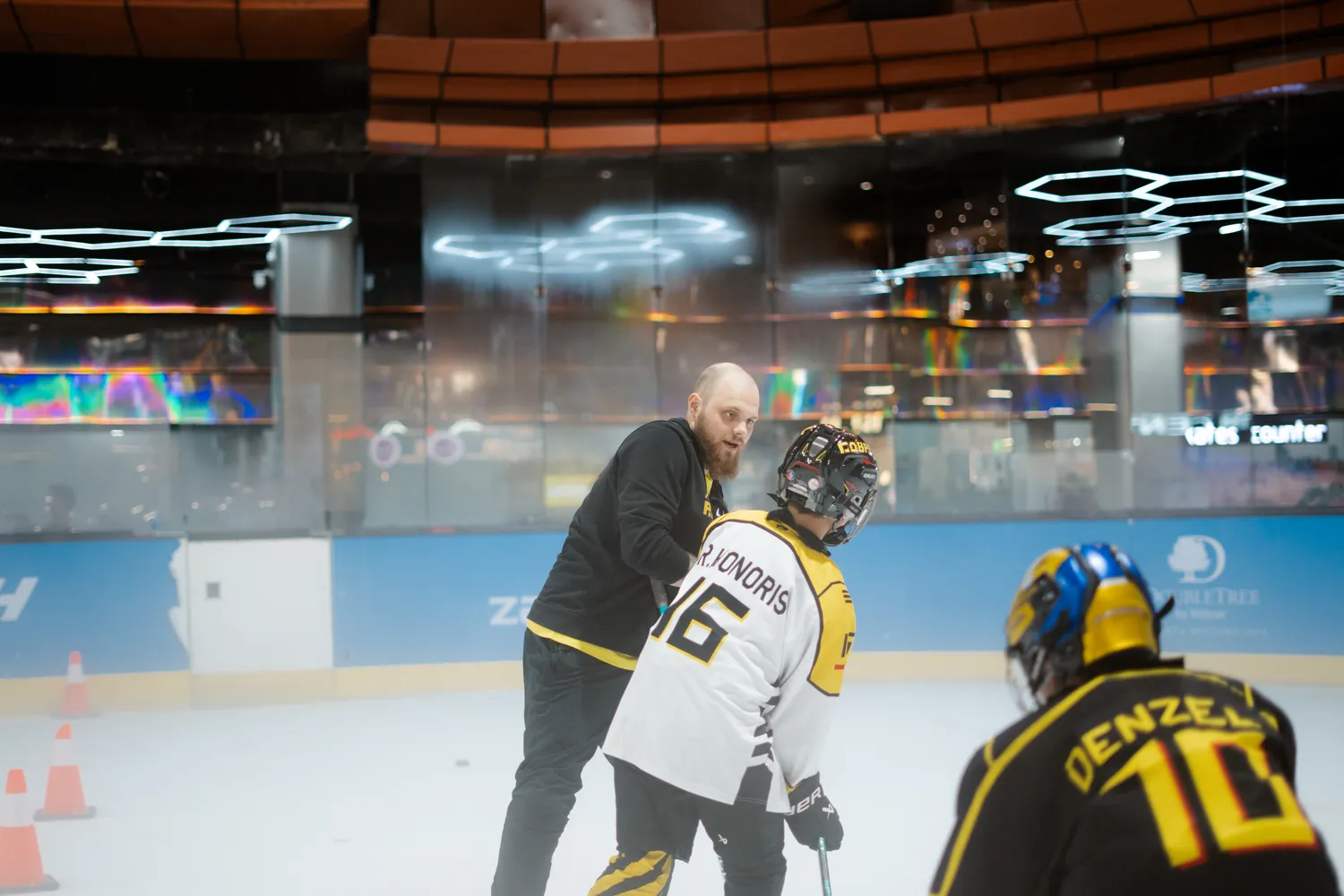 A coach teaching players during group practice